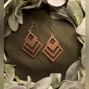 Intricately laser-cut, dark wood earrings